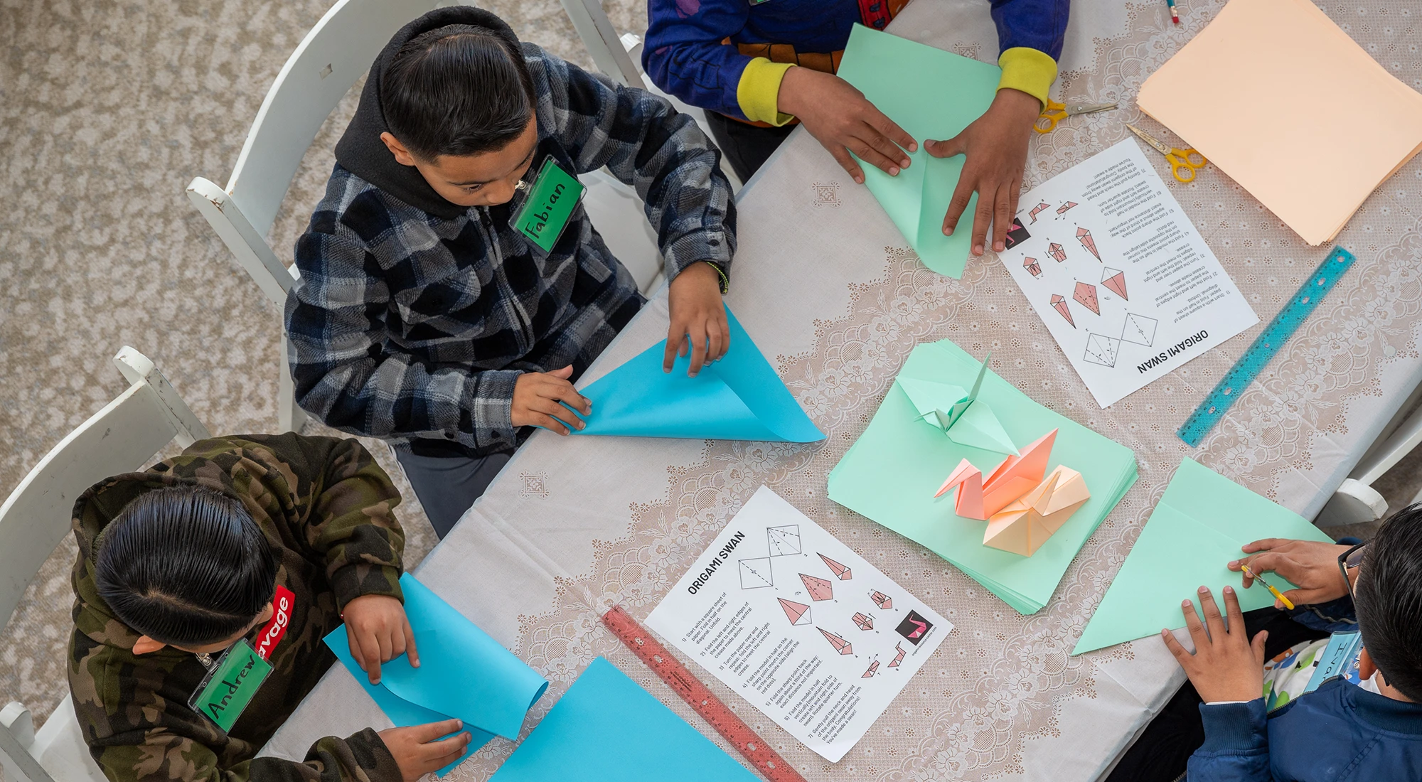 Lobby activities at a Family Musical Mornngs concert - children creating origami animals