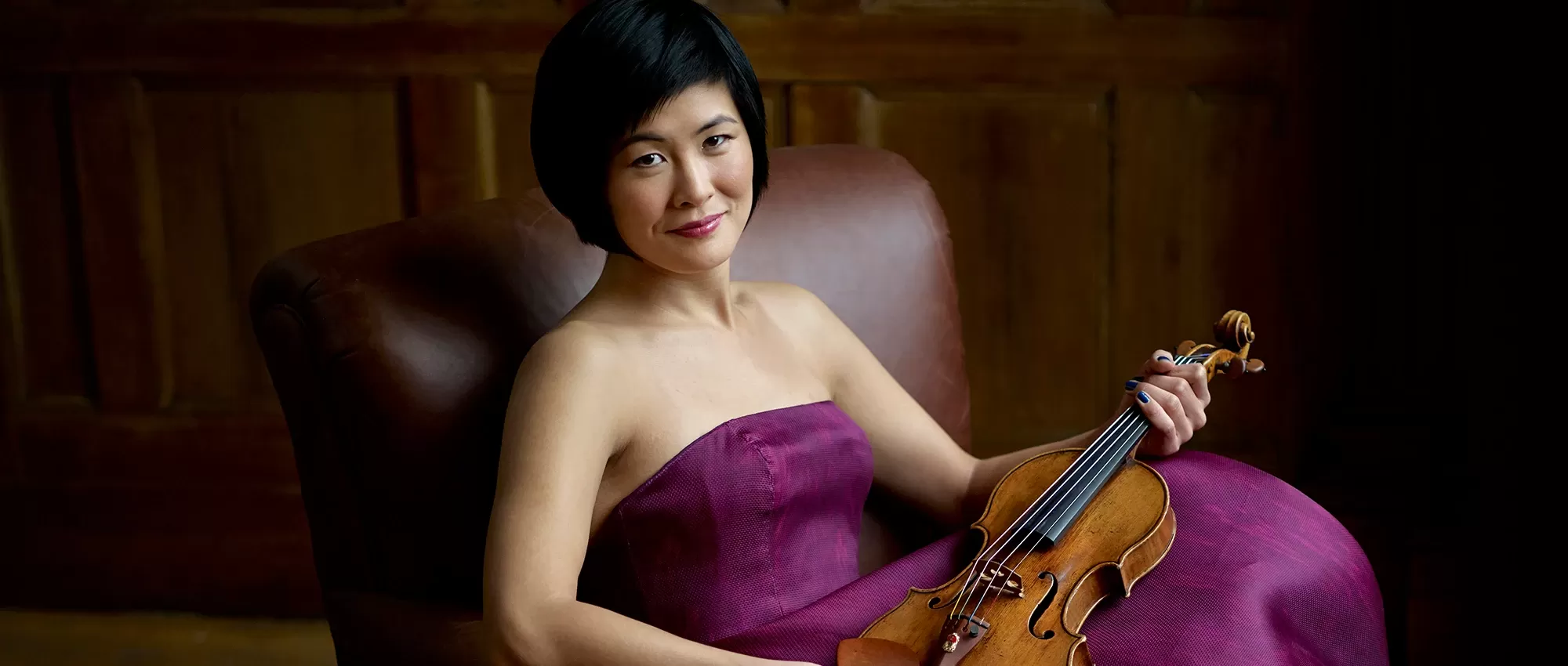 Jennifer Koh in a purple dress withh her violin