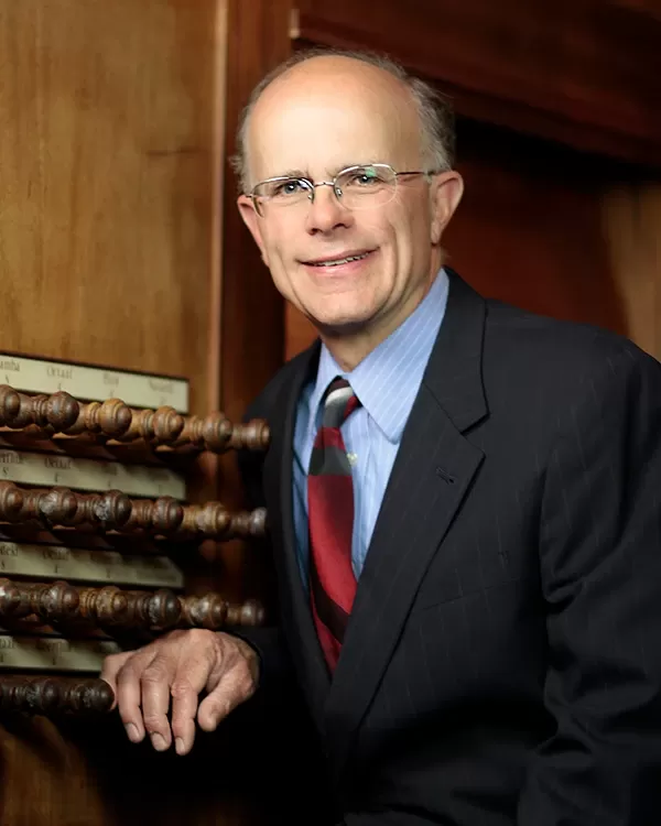 Organist Todd Wilson next to organ stops