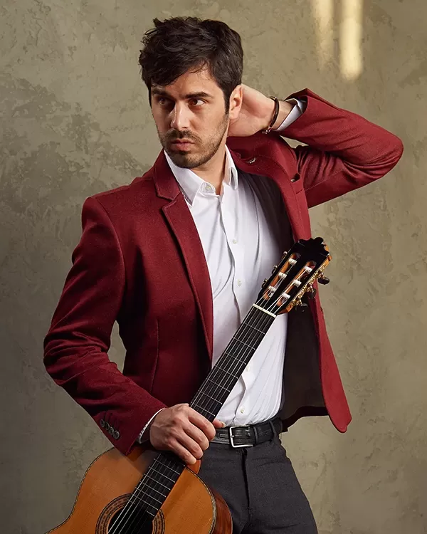 Guitarist Mak Grgic in a red jacket