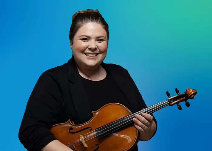 Meredith Crawford smiling and holding her viola