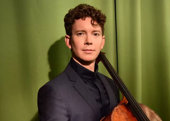 Joshua Roman with his cello in his hands